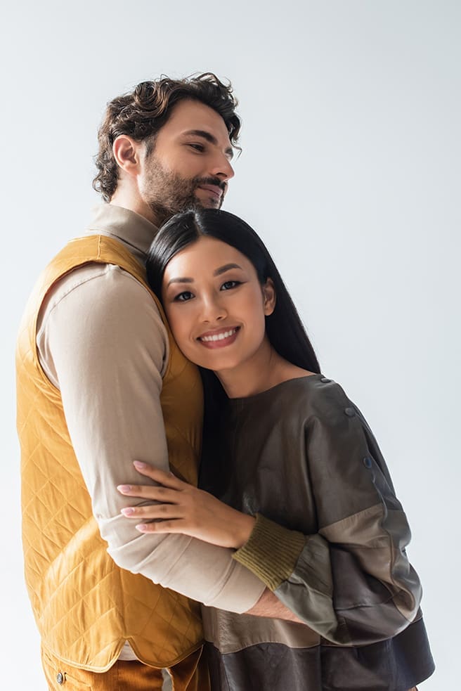 cheerful-asian-woman-in-leather-pullover-leaning